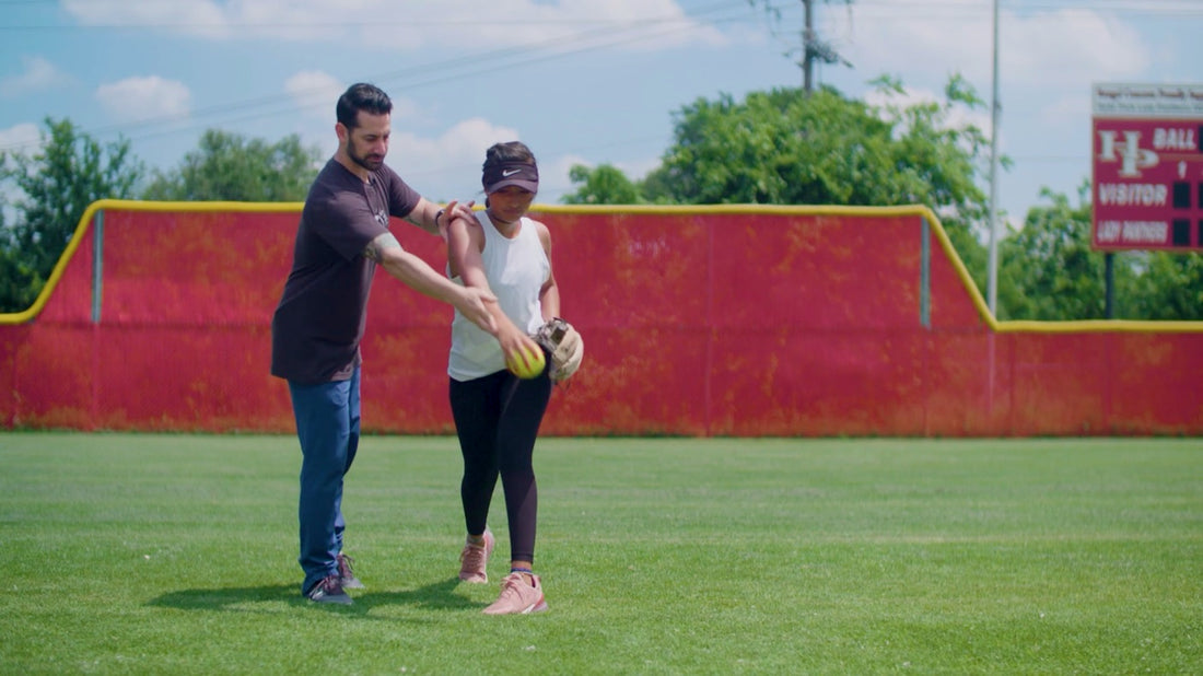 High Level Throwing coaching a softball athlete through an overhand throw